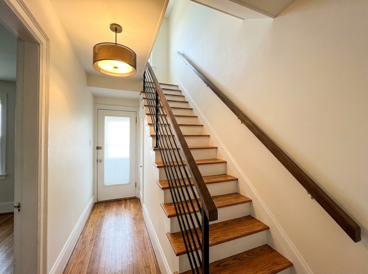 Refinished hardwood staircase with black balusters after refresh